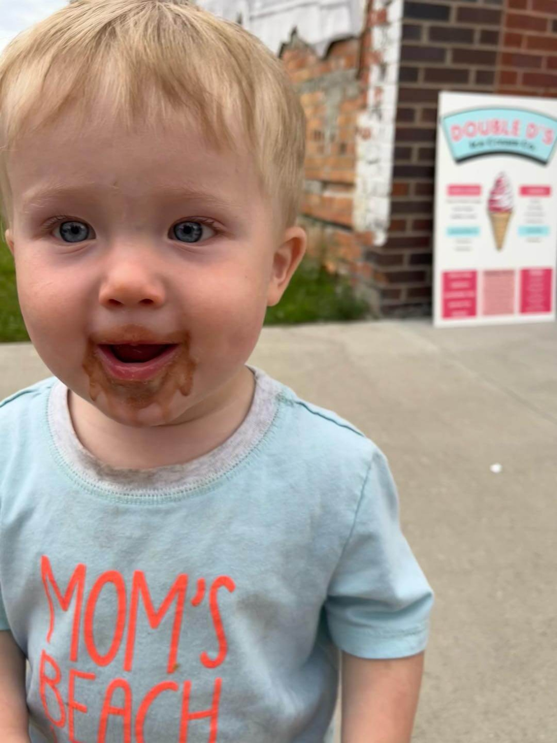 Child eating ice cream outside Double D's Ice Cream Co.